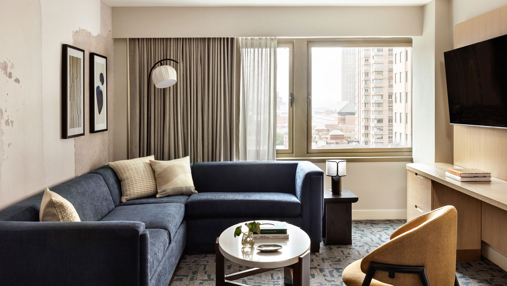 Suite desk and TV with peek of bedroom