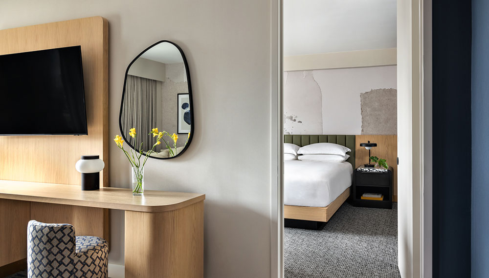 Kimpton theta guestroom with view of bedroom from sitting area